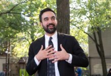 Bin Laden Message? NYC Sparks Outrage Man in suit speaking with hands on chest outdoors