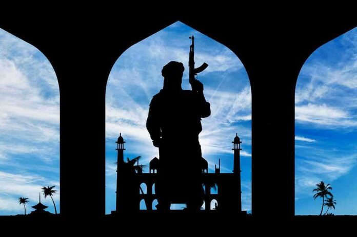 shutterstock_340068836 Silhouette of armed person standing before arches with mosque and palm trees at sunset sky