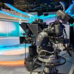 Merger Jitters – Star Bolt Hints At Brutal CNN Shakeup robotic television cameras on a modern news studio set