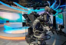 Merger Jitters – Star Bolt Hints At Brutal CNN Shakeup robotic television cameras on a modern news studio set