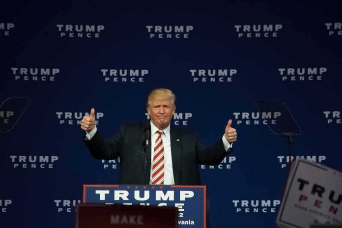 shutterstock_487546267 man at podium giving two thumbs up