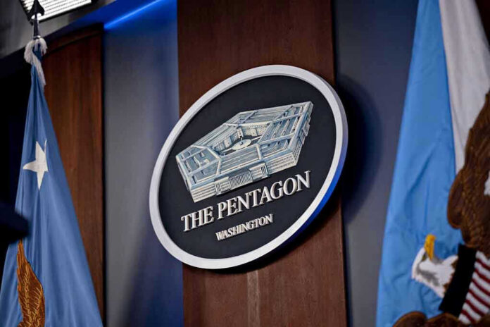 2265798341-1 The Pentagon emblem between two flags.