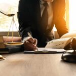 Court Twist: Musk Giveaway Rigged? Lawyer writing at desk with scales and gavel