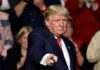 Donald Trump points toward the audience at an event