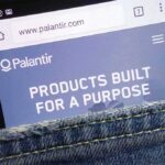 Palantir Whiplash: Yields Jump, Valuations Crack Smartphone showing Palantir website in a denim pocket