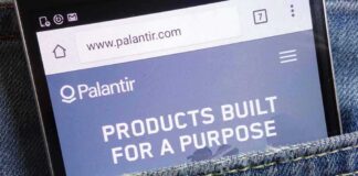 Smartphone showing Palantir website in a denim pocket
