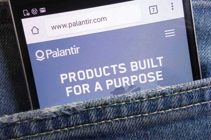 Smartphone showing Palantir website in a denim pocket