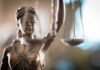No-Bond Shock: Court Supercharges Trump Detention Plan Lady Justice statue holding scales