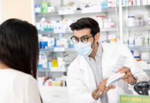 Cold Pills Trigger Hidden Dangers – Read That Label Pharmacist wearing mask explains medication to customer