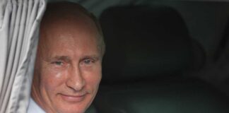 Vladimir Putin smiling in a car window