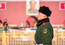 Beijing Cries Trespass, Manila Fires Back uniformed guard in green coat and fur hat standing in profile outdoors