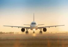 Airplane on runway at sunrise