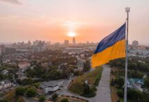 Capital Snubbed: ‘Not Ready’ Shock Ukrainian flag flying over a city at sunset