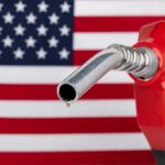 gas pump nozzle with droplet against American flag background