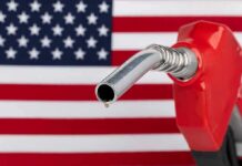 War Costs Jolt Republican Unity gas pump nozzle with droplet against American flag background