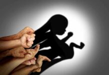 Paid To End Twins? Receipts Shown Hands forming a shadow of a fetus on a wall