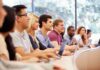 Colleges Stunned: $70K OPT Gatekeeper Fee Students in a lecture hall listening attentively