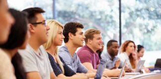 Students in a lecture hall listening attentively