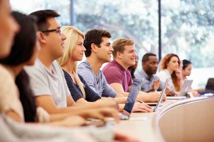 shutterstock_218235067 Students in a lecture hall listening attentively