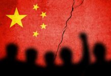 Chinese flag with crack and crowd silhouettes