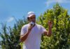Ramaswamy’s $4M Grenade Hits Ohio Race Man in white shirt and cap speaking into a microphone outdoors