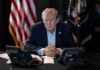 Coast-to-Coast Power Play Begins Donald Trump seated at a table between two desk phones