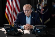 Coast-to-Coast Power Play Begins Donald Trump seated at a table between two desk phones