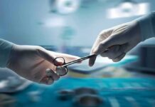 Freshman Star’s Emergency Heart Swap Gloved hands passing surgical scissors in an operating room