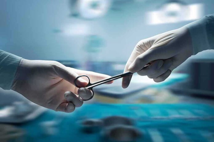 Gloved hands passing surgical scissors in an operating room