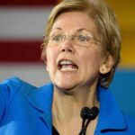 Warren Sounds Alarm: Cheating Ahead? woman speaking at a podium