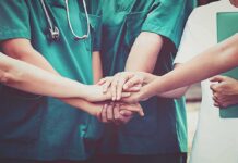 medical team stacking hands in unity