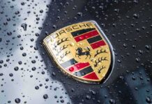 Elite Only: Porsche Hikes 911 Sky-High Porsche crest on wet car hood