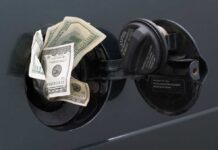 Pump Pain Torpedoes ‘No Inflation’ Claim Cash sticking out of a cars gas tank