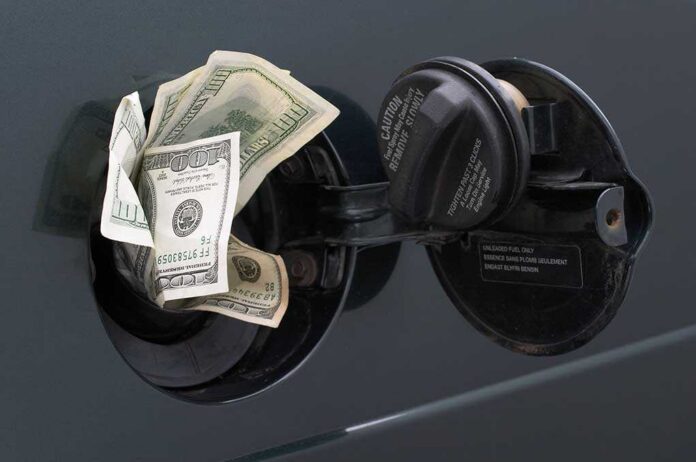 Rising,Gas,Prices Cash sticking out of a cars gas tank